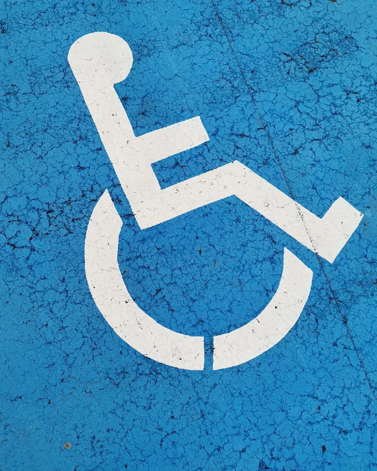 White accessibility logo painted on a blue background